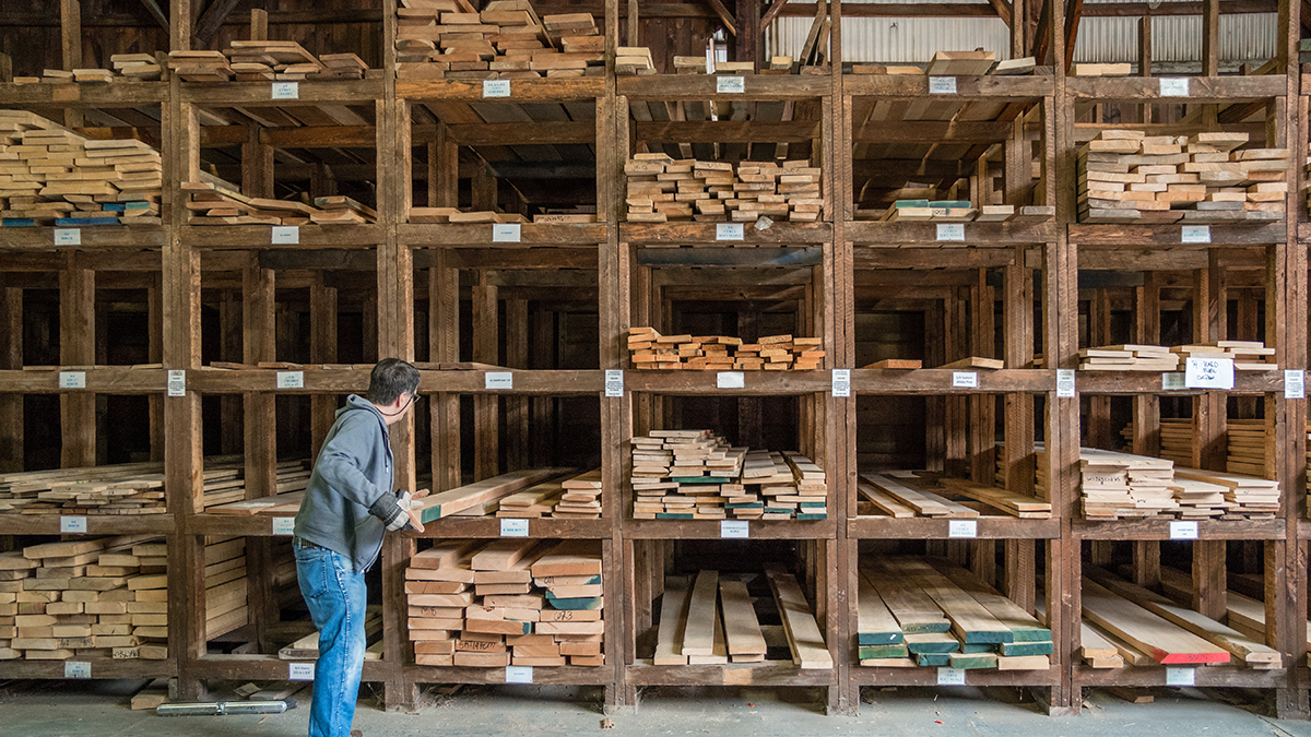 A man pulling out a layer of wood