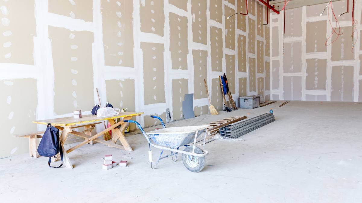 wheelbarrow in a plastered room